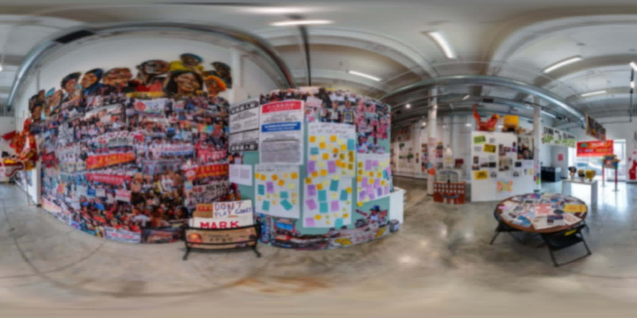 Monumental protest-photo collage beside visitor responses written on colorful notes.