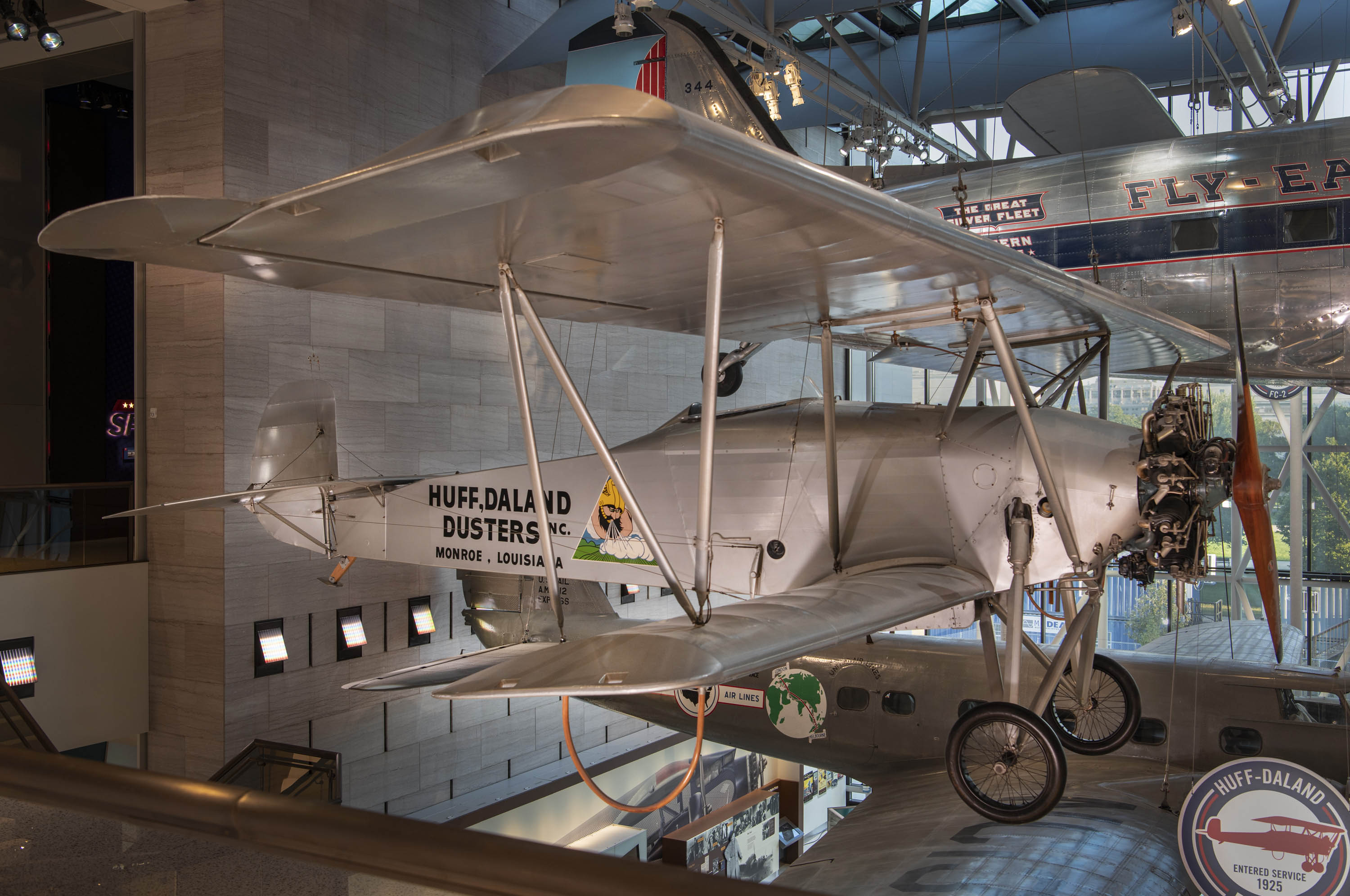 Fabric-covered crop-dusting biplane marked Huff, Daland Dusters Inc. and painted with a Thor logo.