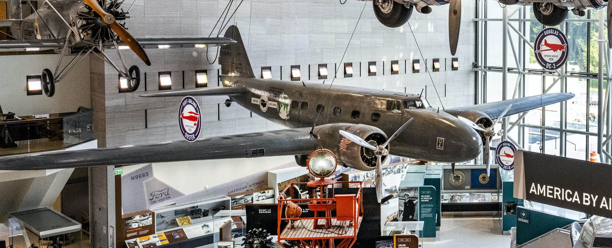 Twin-engine metal monoplane with United Air Lines markings and symbols from the London-to-Melbourne air race.