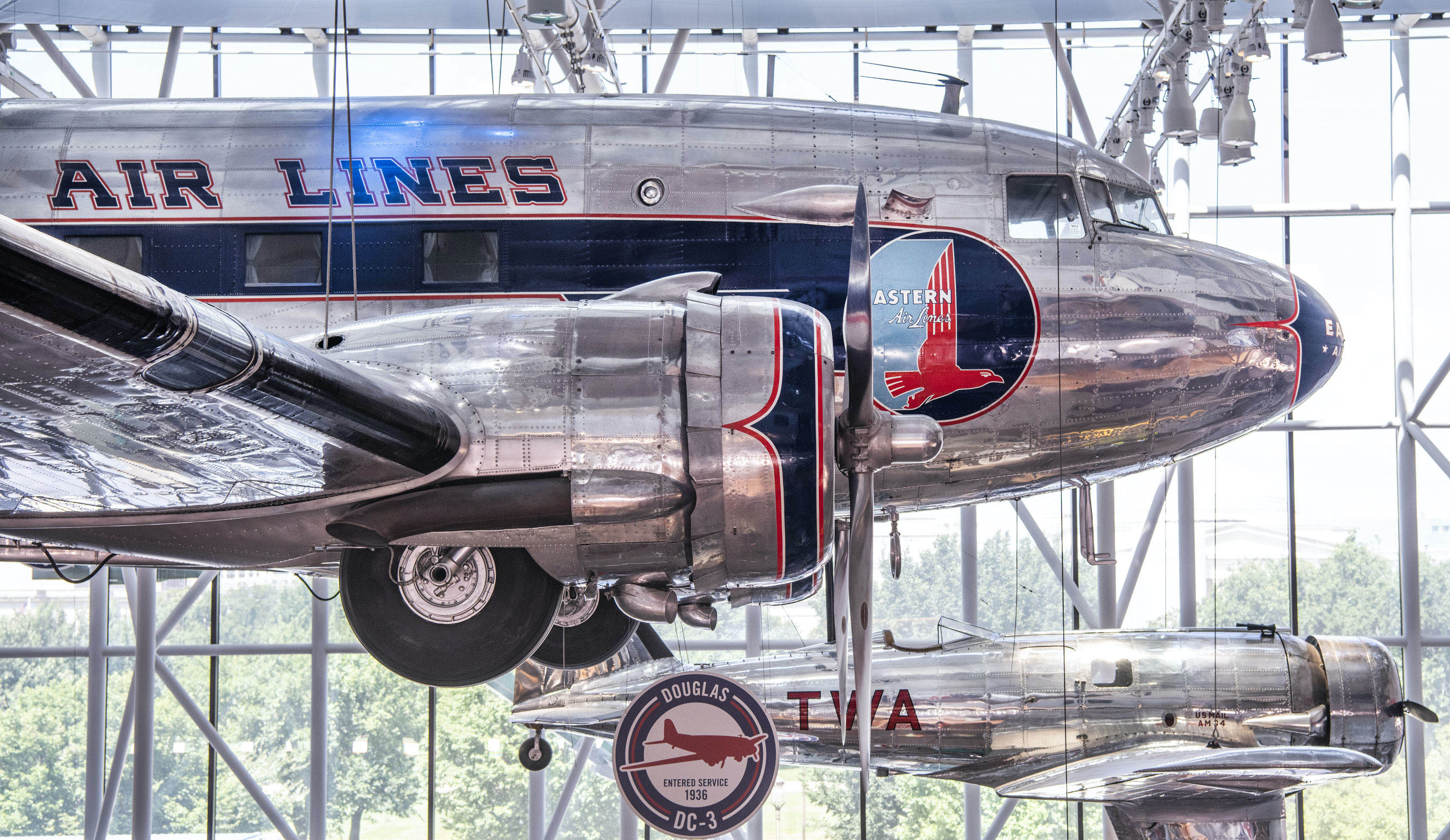 Silver twin-engine Eastern Air Lines monoplane with blue trim and an eagle emblem.