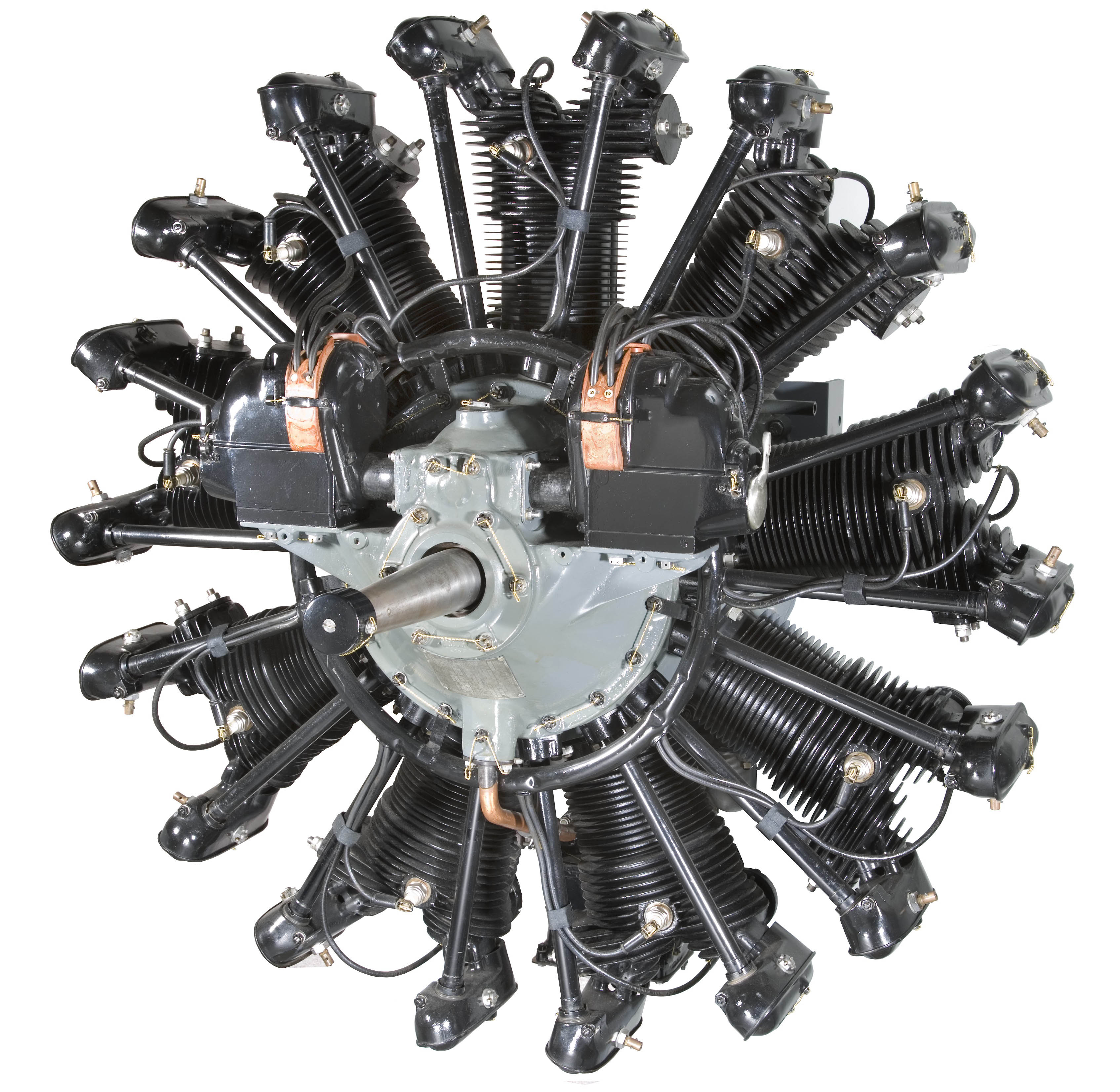 Nine-cylinder radial engine with a gray crankcase, black cylinders, magnetos, and a central propeller shaft.