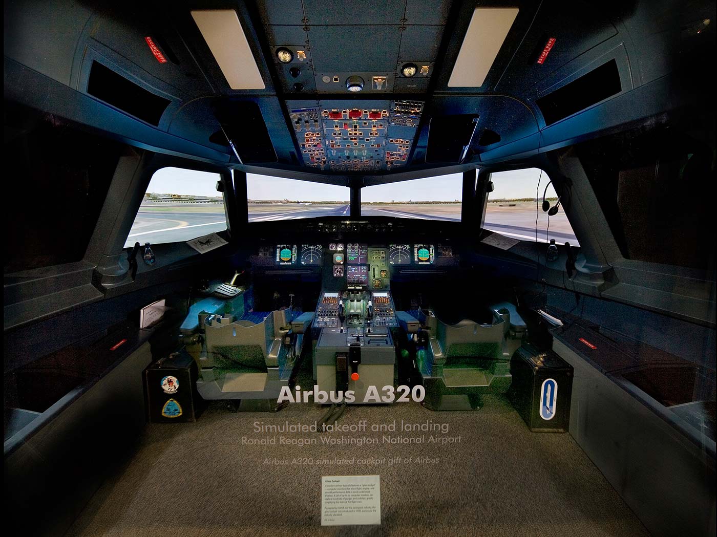 Full-scale A320 cockpit with live instruments and screens simulating a landing at Ronald Reagan Washington National Airport.