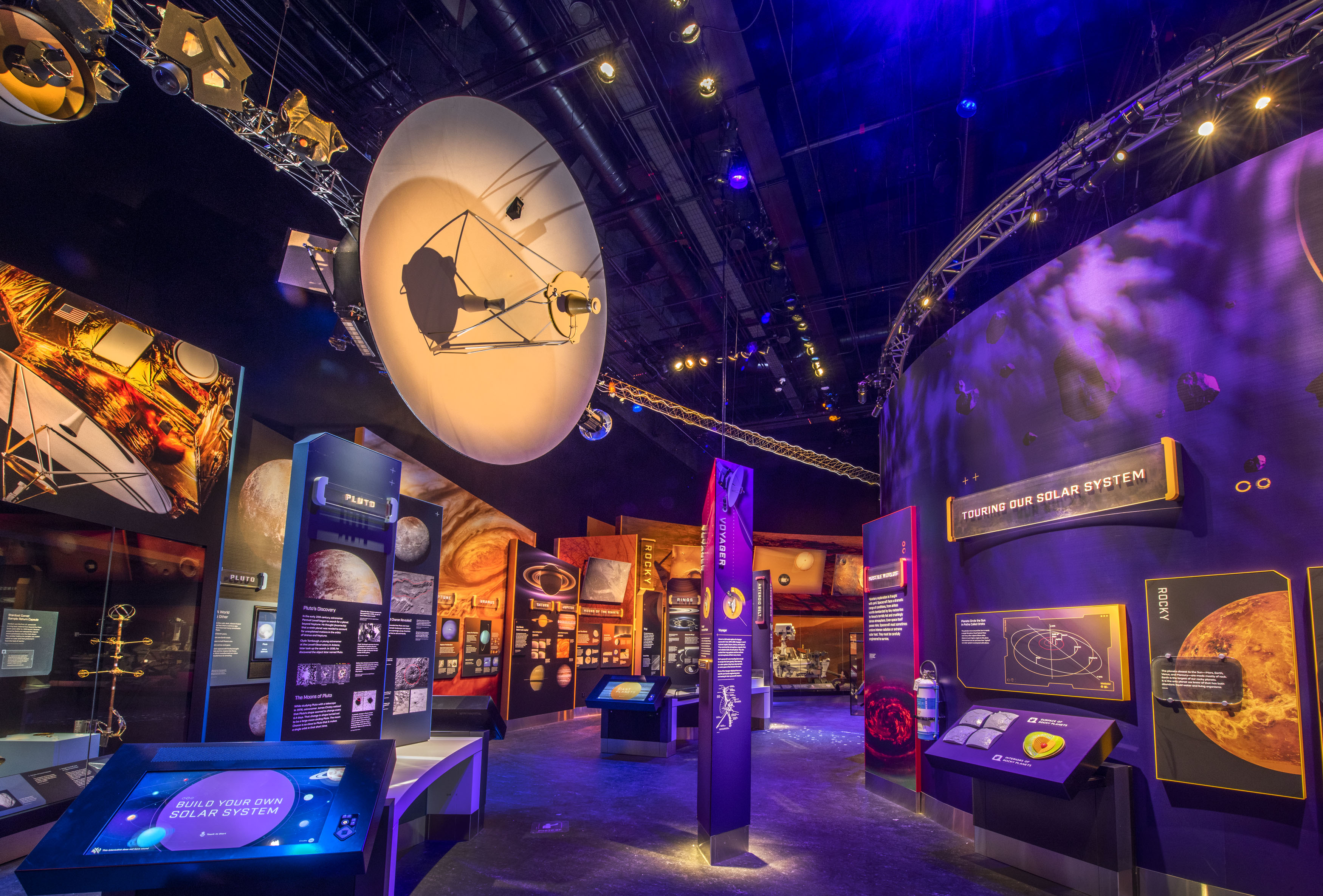 Full-scale Voyager spacecraft replica with a large white dish antenna, instrument booms, cameras, and a radioisotope power source.