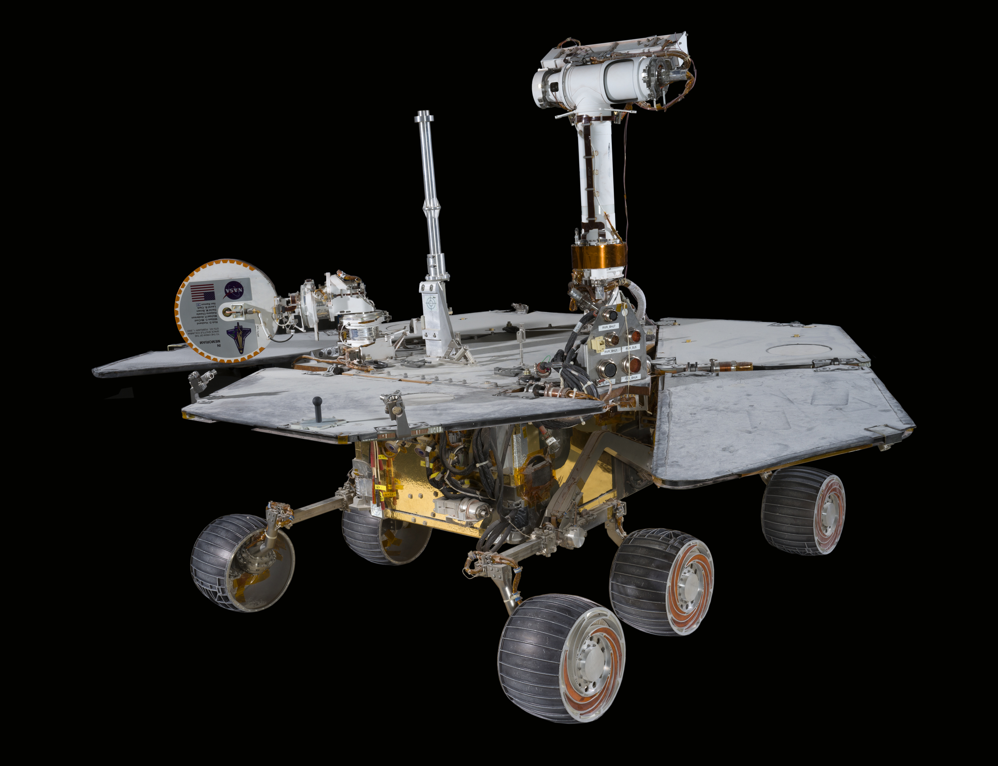 Gold-covered six-wheeled rover test bed with solar panels, a camera mast, antennas, and rocker-bogie suspension.