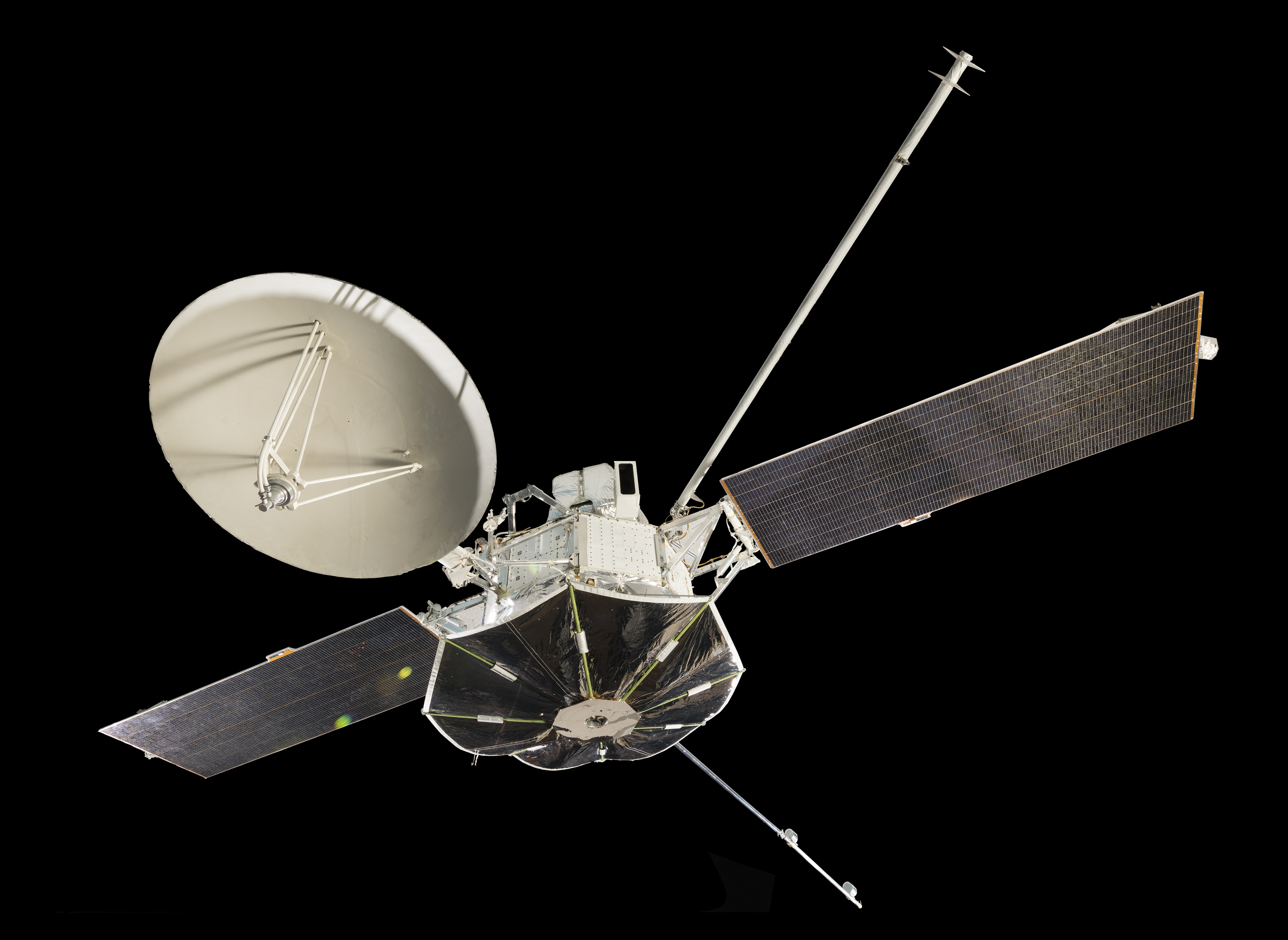 White octagonal spacecraft with two solar panels, a dish antenna, a long instrument boom, and a protective sunshade.