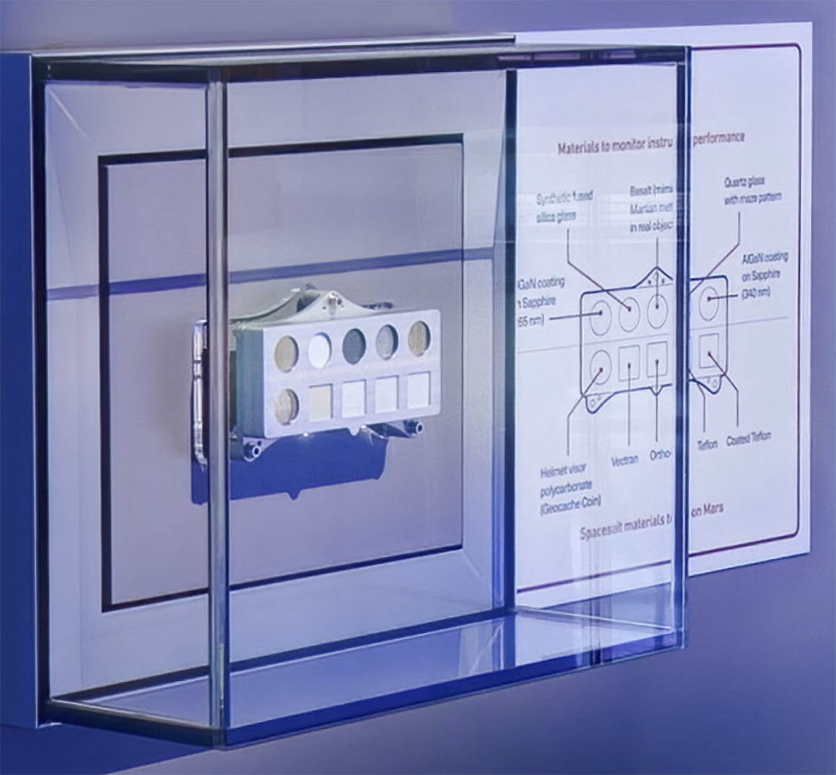 A small rectangular metal calibration tray with ten round and square spacesuit-material samples for testing on Mars.