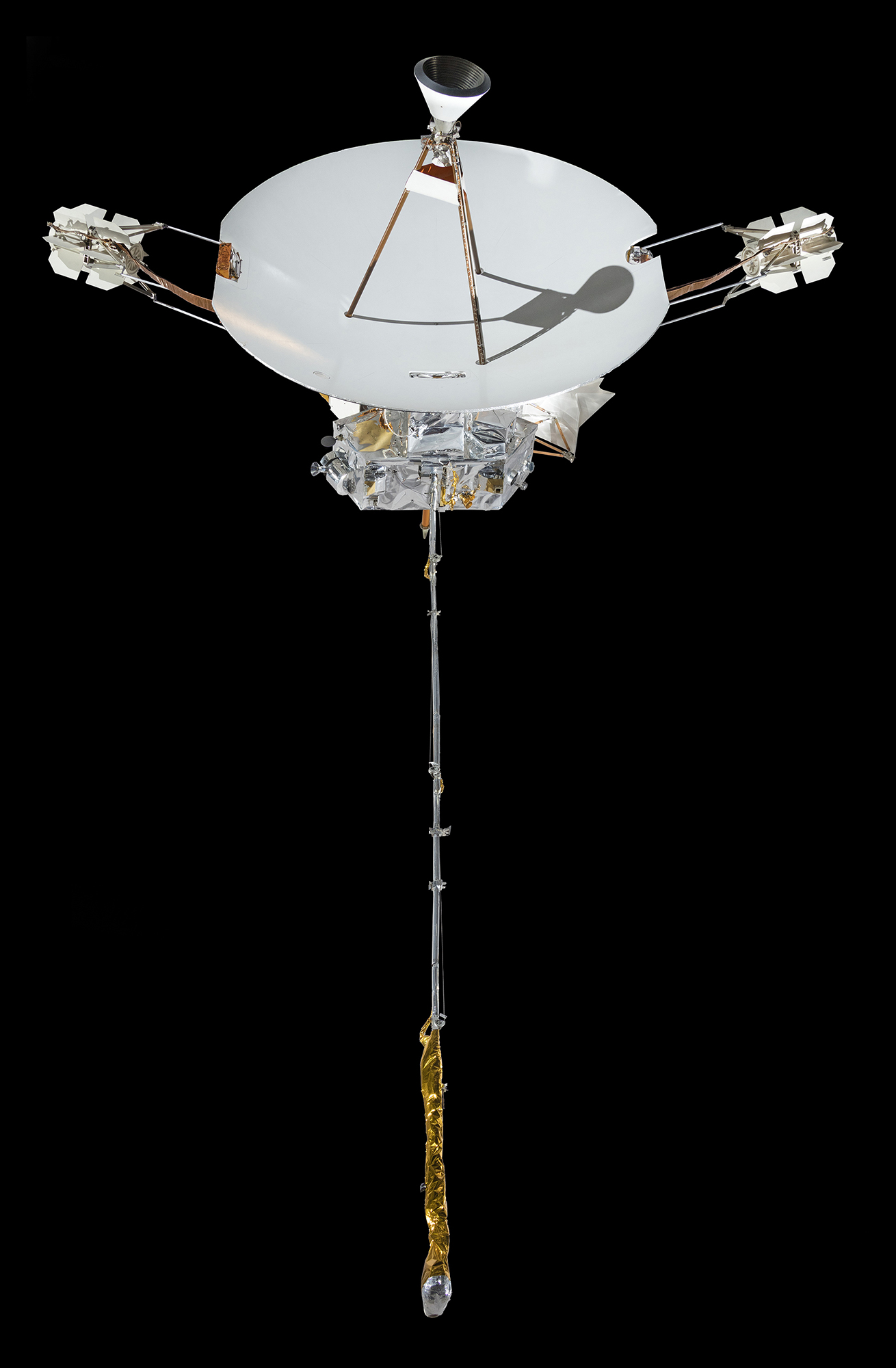 A deep-space probe with a large white dish antenna attached to a compact hexagonal equipment body and long instrument booms.