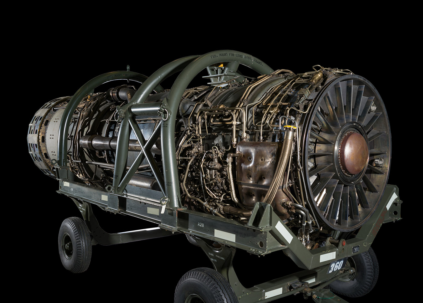 Large cylindrical turbojet engine with external fuel and oil lines visible along its casing.