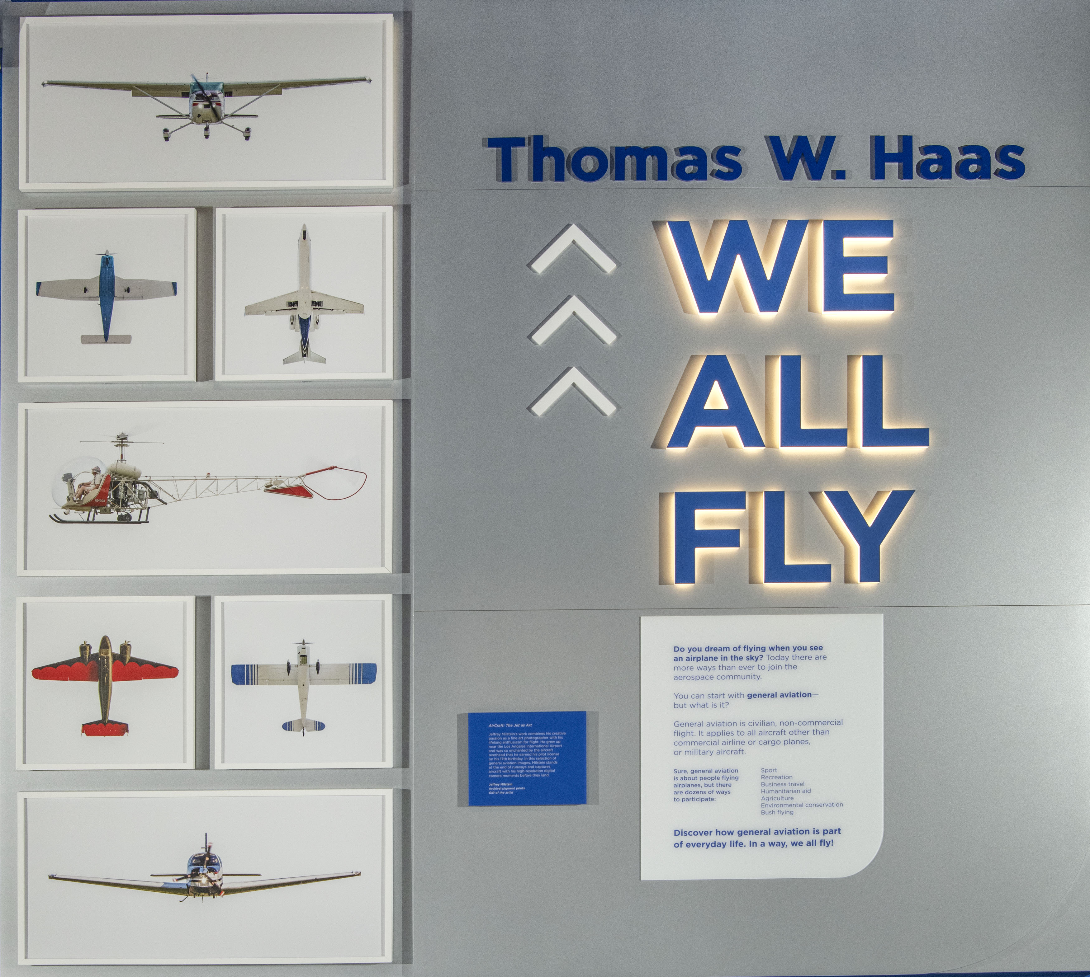 Seven detailed aircraft photographs displayed in white frames as a vertical art installation.