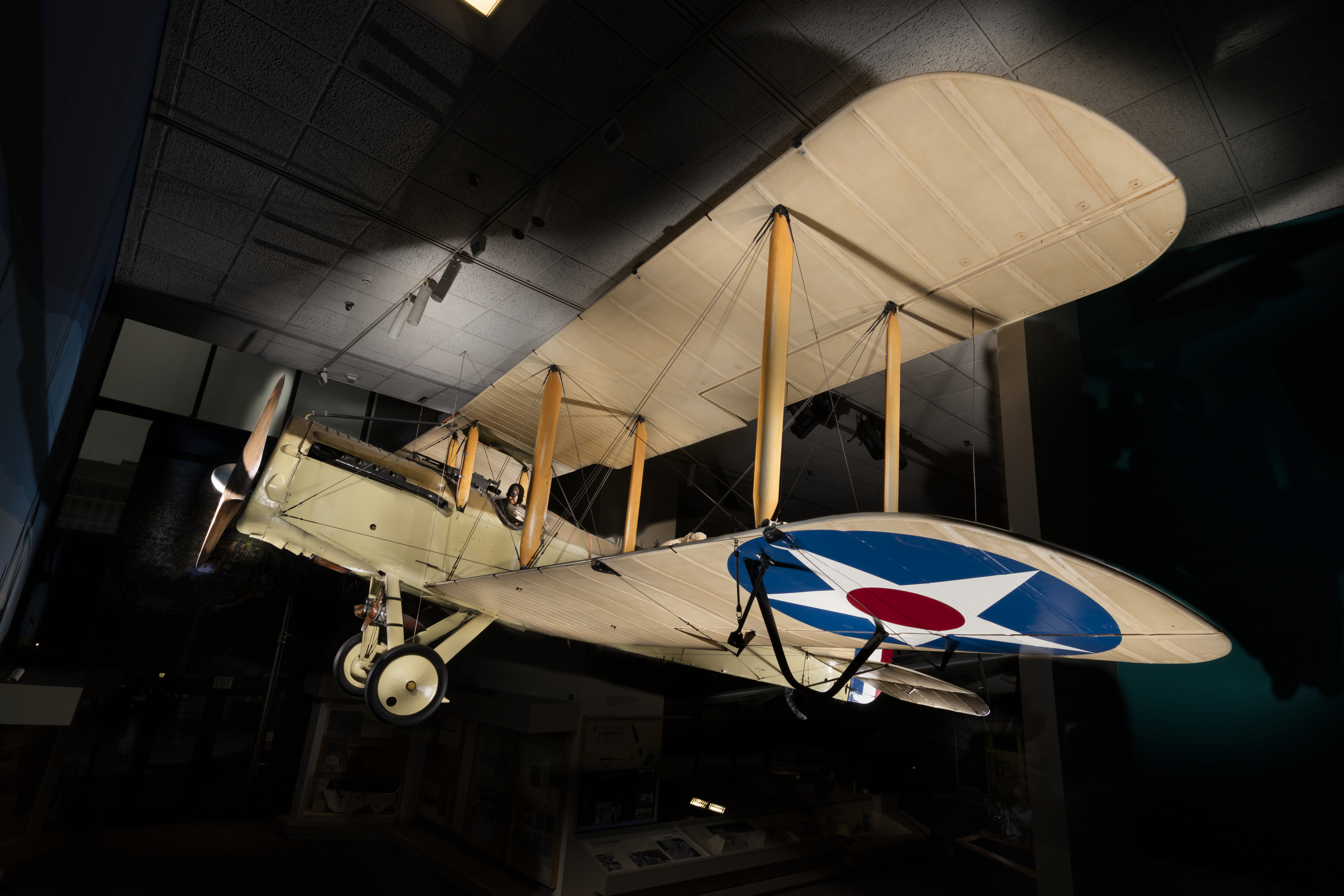 Natural-finish two-seat DH-4 biplane with a Liberty V-12 engine and military markings.