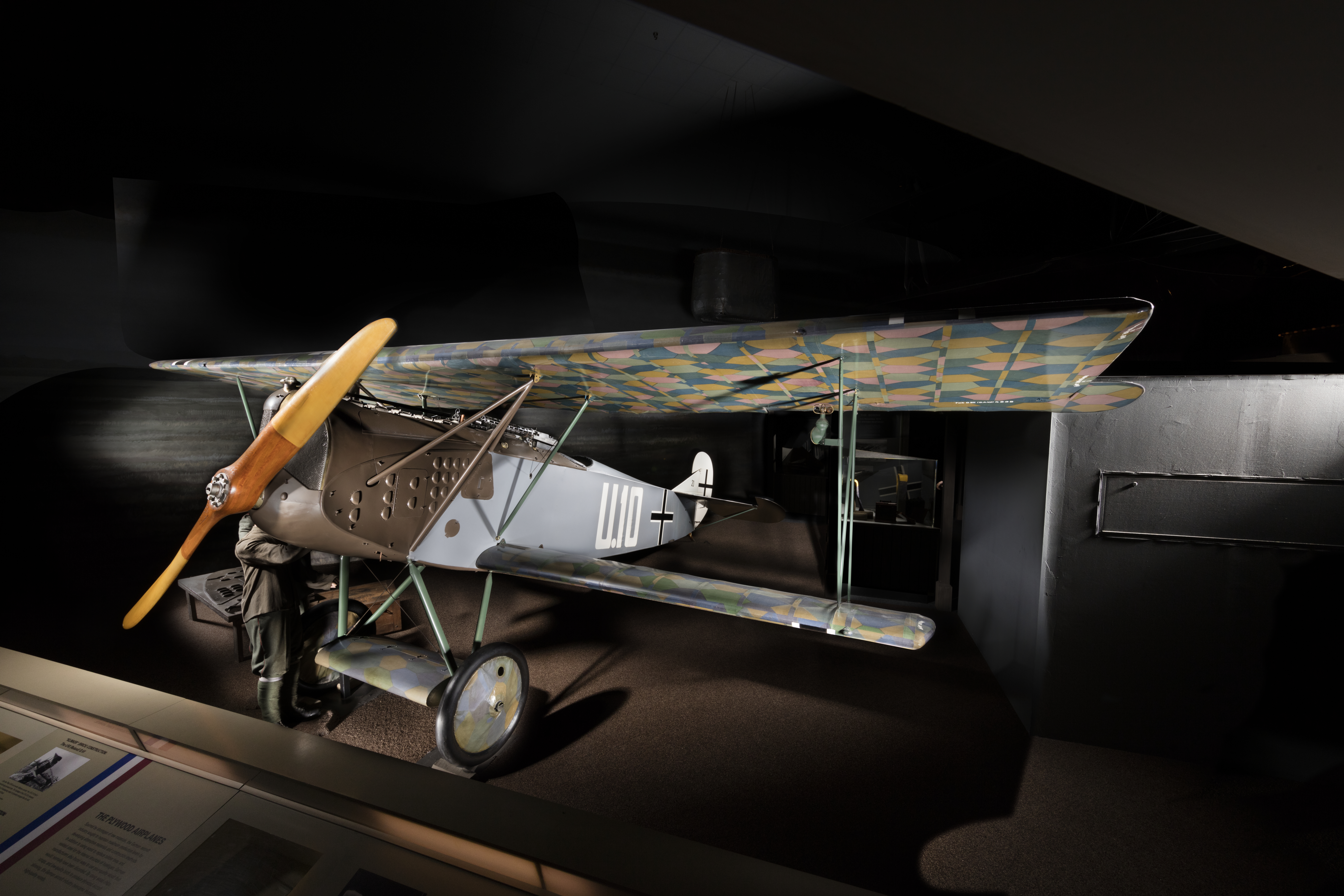 German single-seat Fokker D.VII biplane fighter with lozenge camouflage and gray-green fuselage.