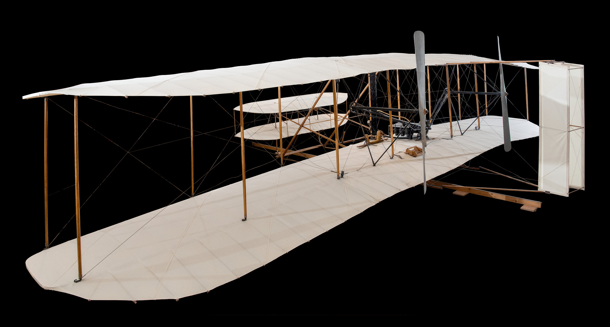 Canard biplane with a horizontal four-cylinder engine, twin pusher propellers, landing skids, and a prone pilot position.