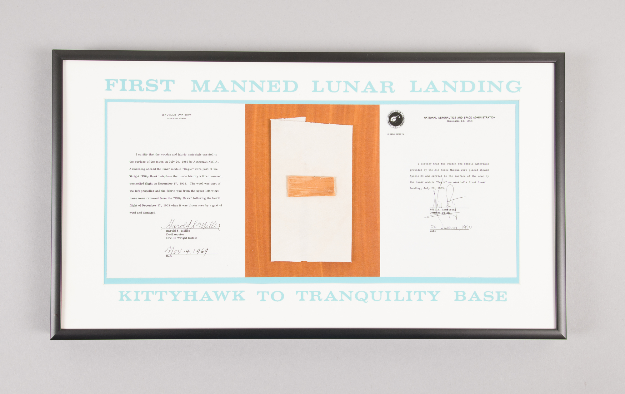 Framed plaque containing wood and fabric from the Wright Flyer, flanked by authenticity letters, after the pieces traveled to the Moon on Apollo 11.
