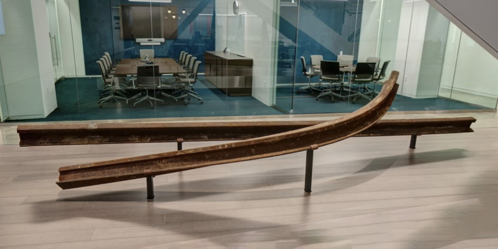 Parallel metal rails forming an architectural path through the exhibition