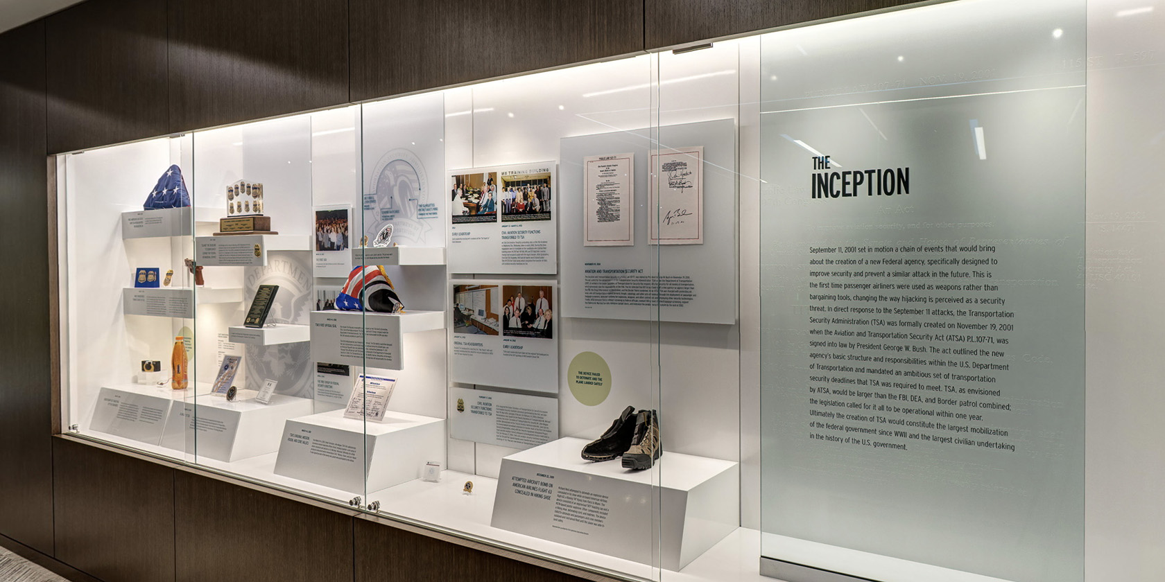 Exhibit case labeled The Inception, containing early TSA objects, photographs, and timeline material